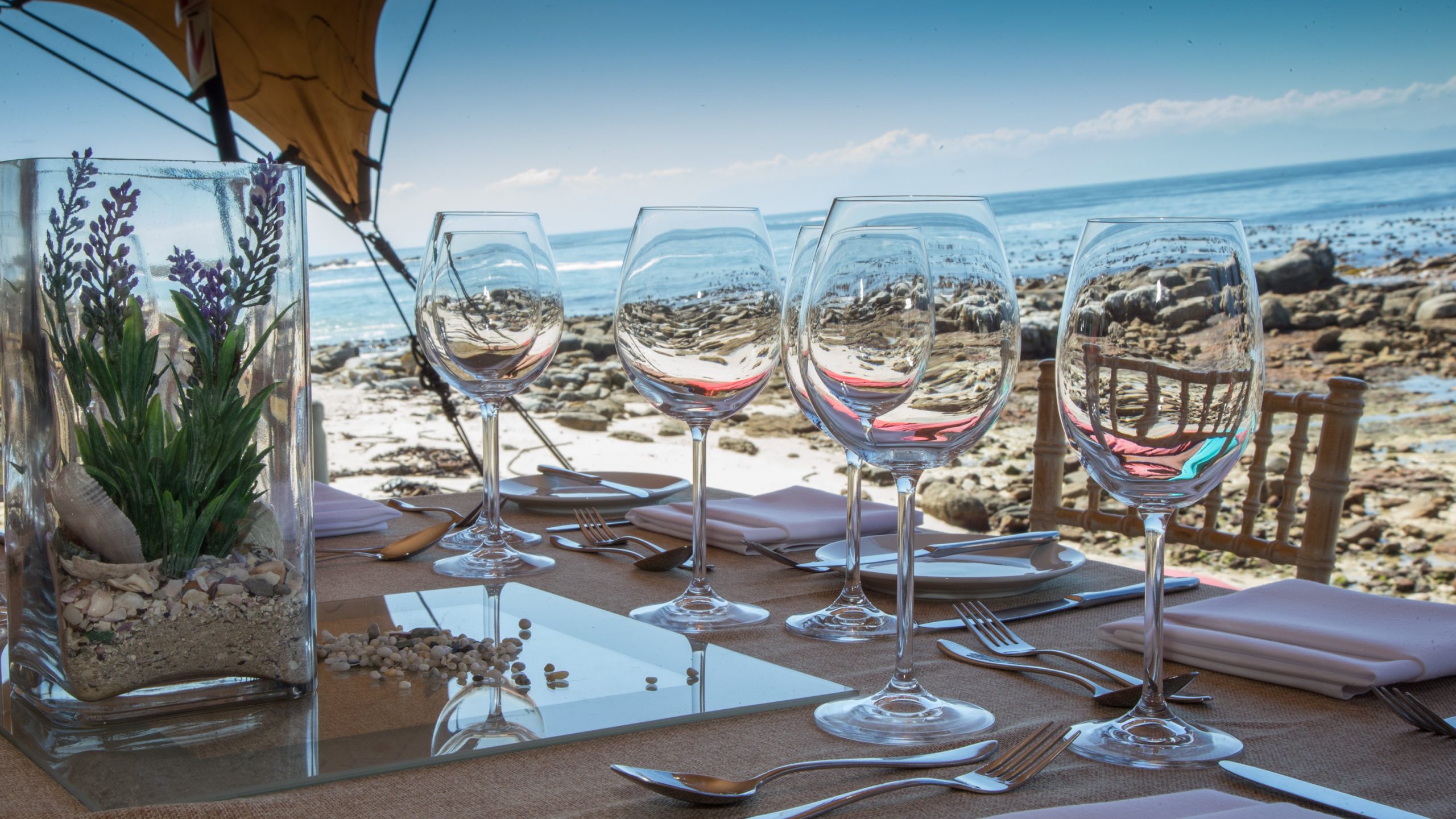 Glassware and place settings overlooking the ocean
